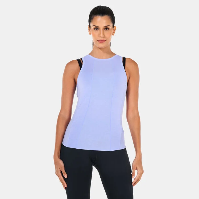 Woman wearing a sleeveless Nike lavender training top paired with black leggings for fitness and studio workouts