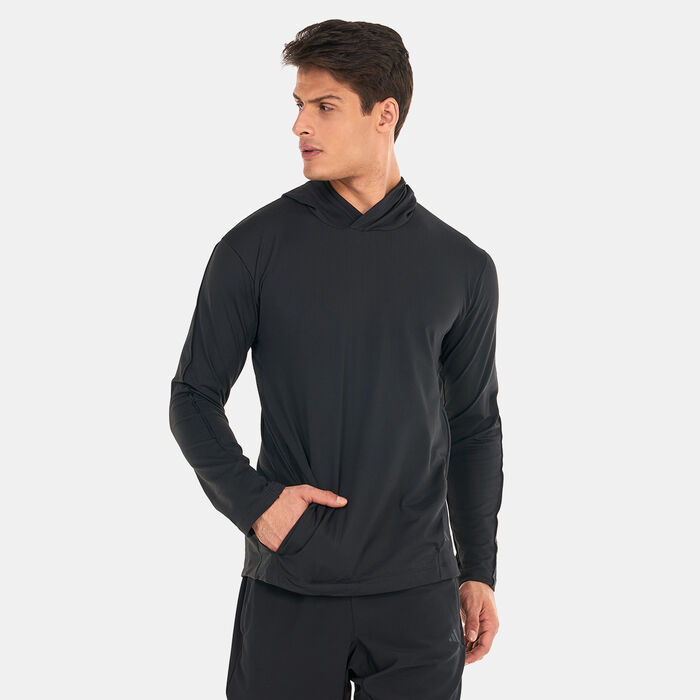 Man wearing a black long-sleeve adidas training top with a hood, designed for warm-ups, stretching, and light workouts