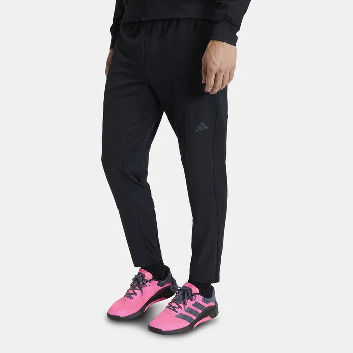 Men’s black tapered adidas training joggers paired with pink adidas training shoes, suitable for gym and everyday movement