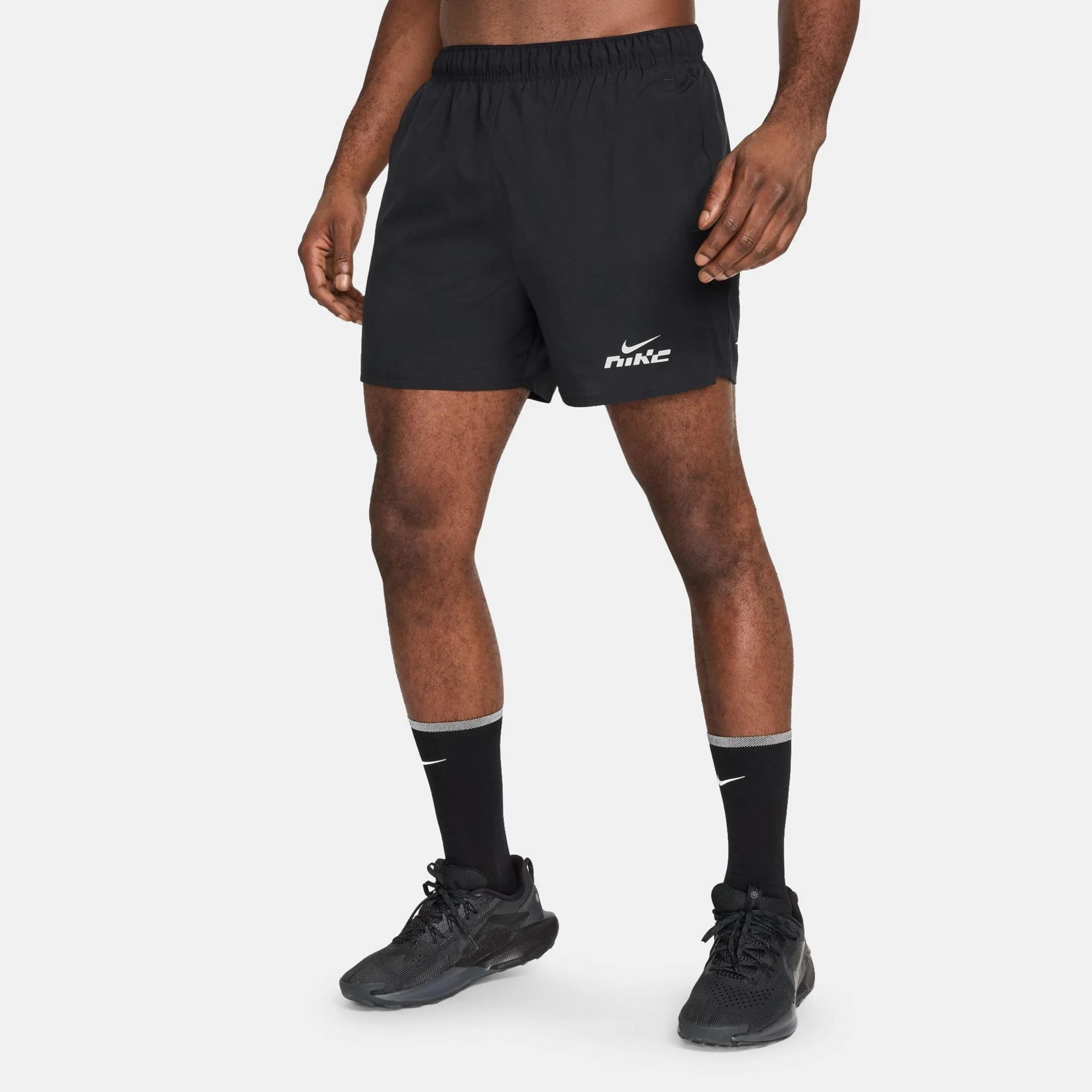 Man wearing black Nike Challenger Flash Dri-FIT running shorts with Nike socks and shoes