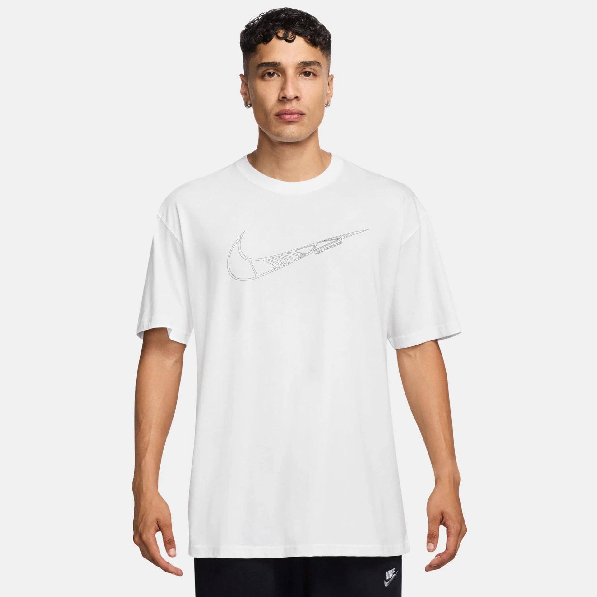 Nike men’s white short-sleeve t-shirt with subtle swoosh graphic and relaxed fit.